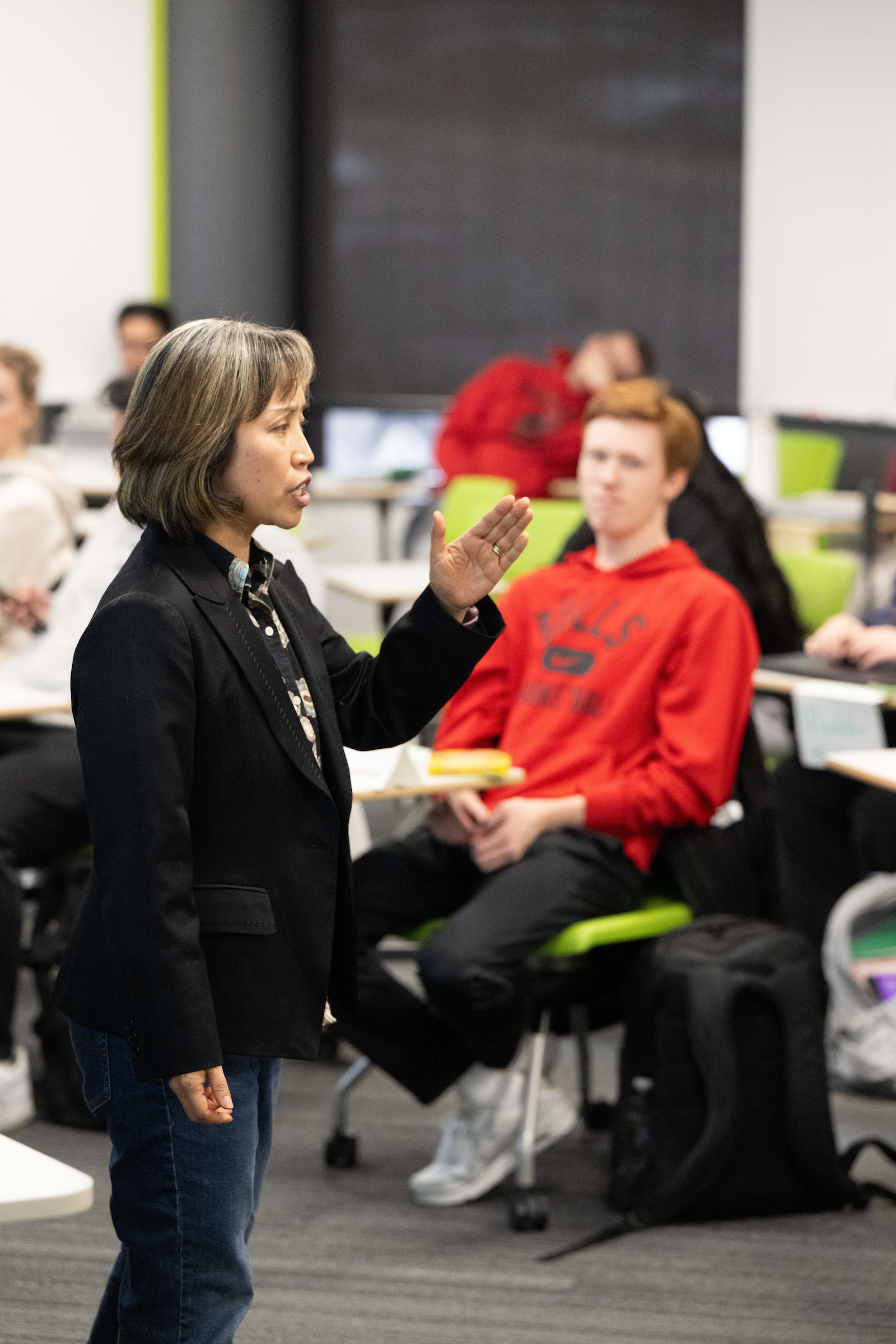 Person lecturing before a group of seated students