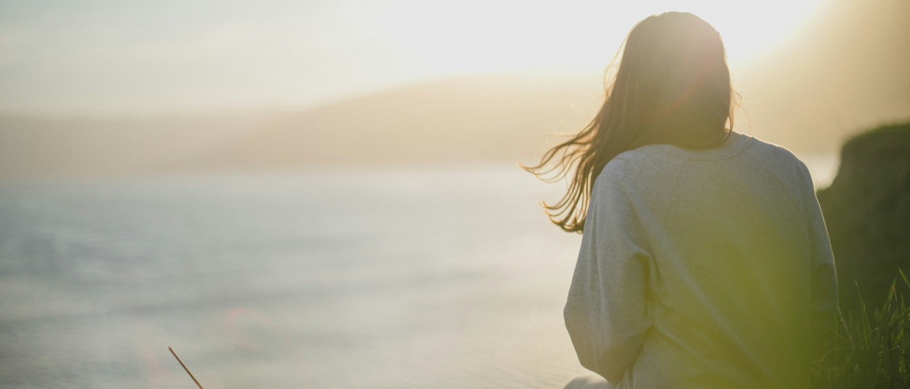 Woman sitting with sunlight behind her