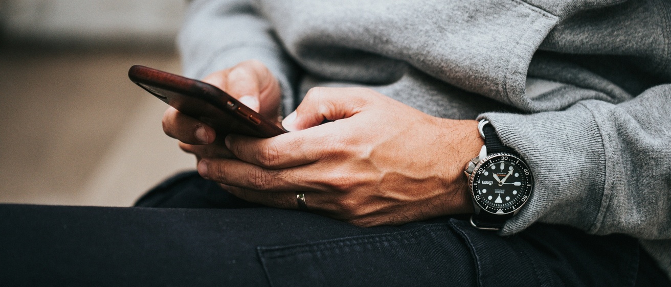 Person holding cell phone 