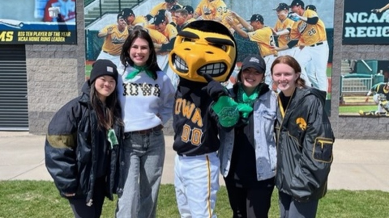 College students huddle around Herky